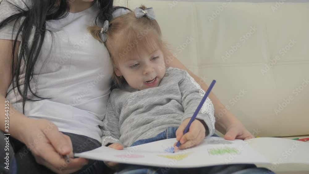 little girl lifestyle and mom draw teamwork happy family concept. child daughter with woman are a engaged in pencil drawing lesson with children development of creativity little girl lifestyle and mom draw teamwork happy family concept. child daughter with woman are a engaged in pencil drawing lesson with children development of creativity