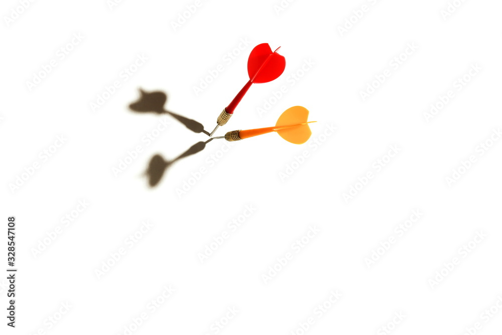 two darts sticking out of white space with shadows on a white background two darts sticking out of white space with shadows on a white background