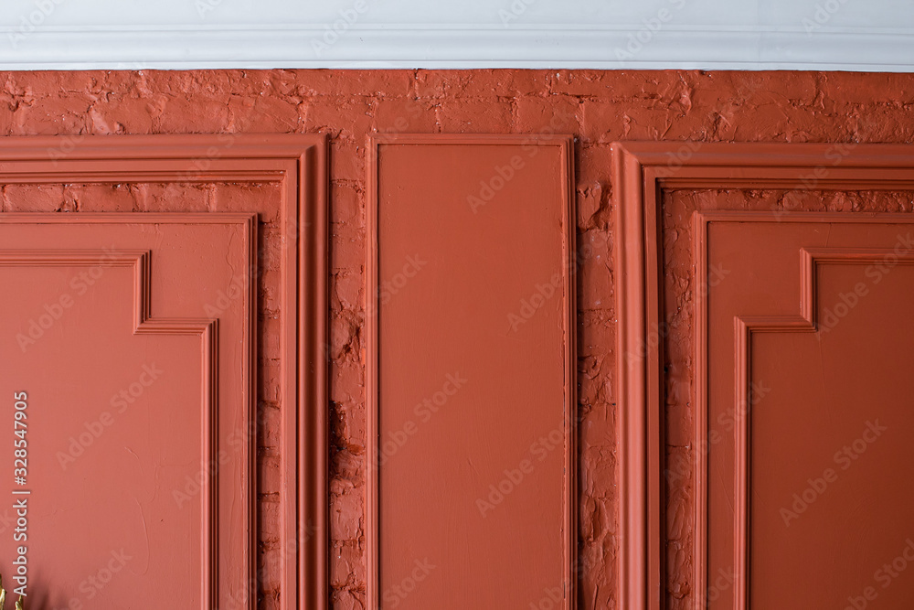 Redecoration of loft apartment, Finishing Works - Fragment Of Classic Red Wall With Installed Wall Plaster Panels, Decorated With Moldings. Сorner of the frame baguette Redecoration of loft apartment, Finishing Works - Fragment Of Classic Red Wall With Installed Wall Plaster Panels, Decorated With Moldings. Сorner of the frame baguette