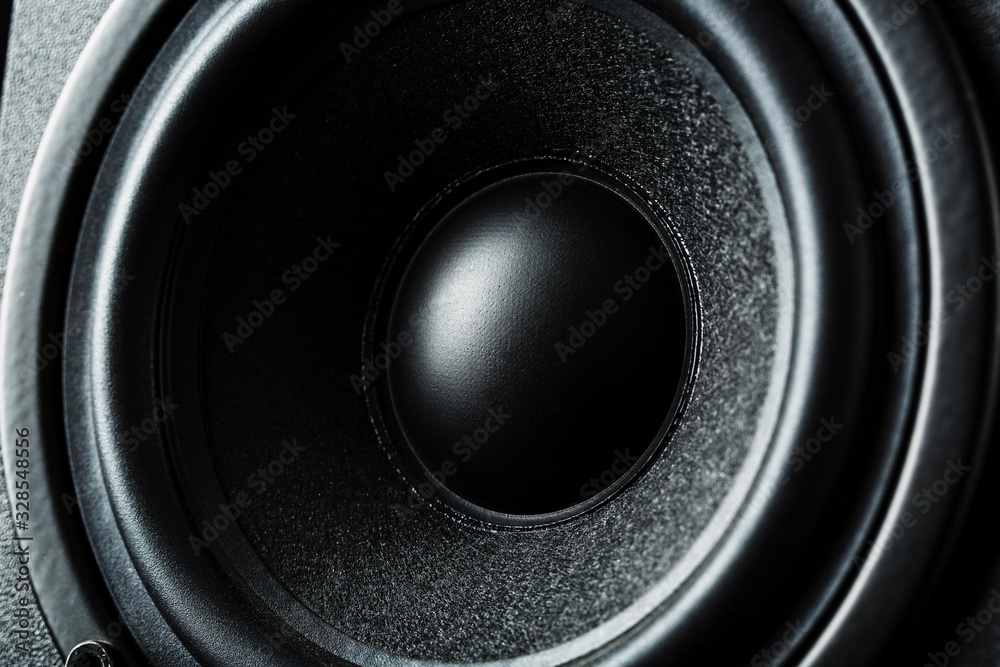 Multimedia speaker system speaker close-up on a black background. Multimedia speaker system speaker close-up on a black background.