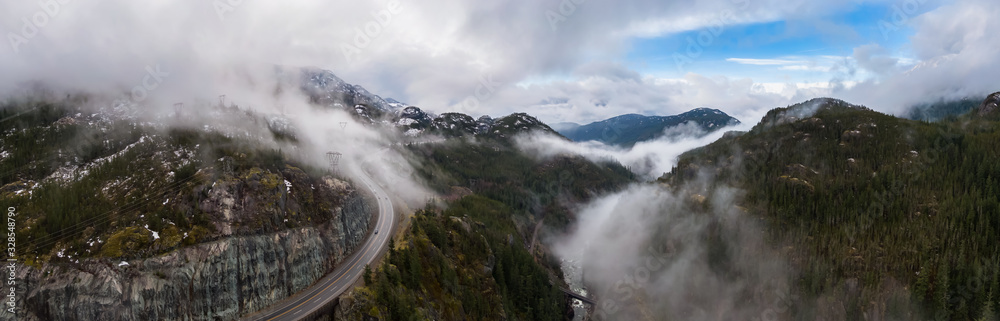 Aerial Panoramic drone view of Sea to Sky Highway during a cloudy winter morning. Taken between Squamish and Whistler, North of Vancouver, British Columbia, Canada. Panorama