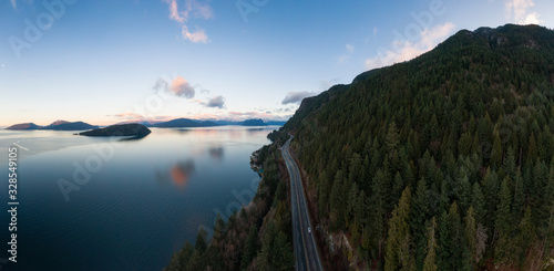 Sea to Sky Hwy in Howe Sound near Horseshoe Bay, West Vancouver, British Columbia, Canada. Aerial panoramic view during a colorful sunrise in Winter Season. Panorama