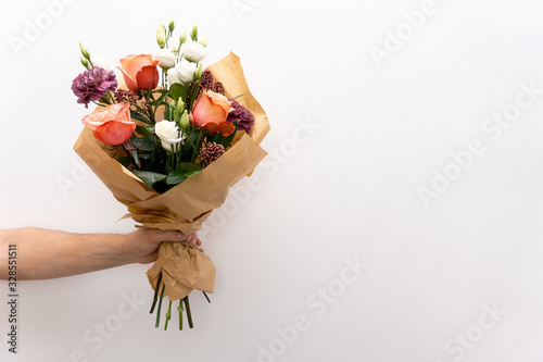 Fotobehang Beautiful bouquet in hands hand on white background