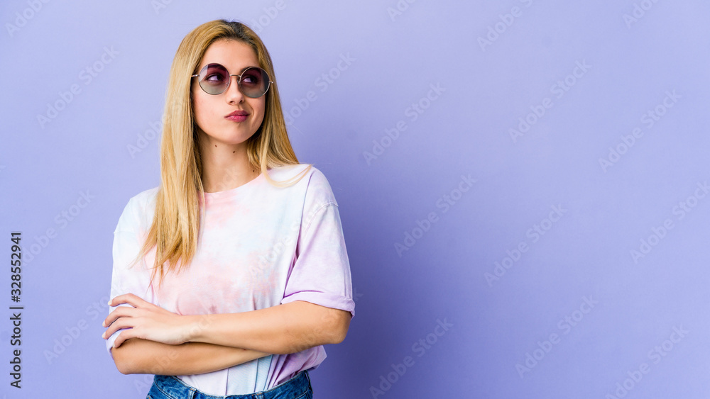 Young hipie woman with glasses isolated on purple background tired of a repetitive task.