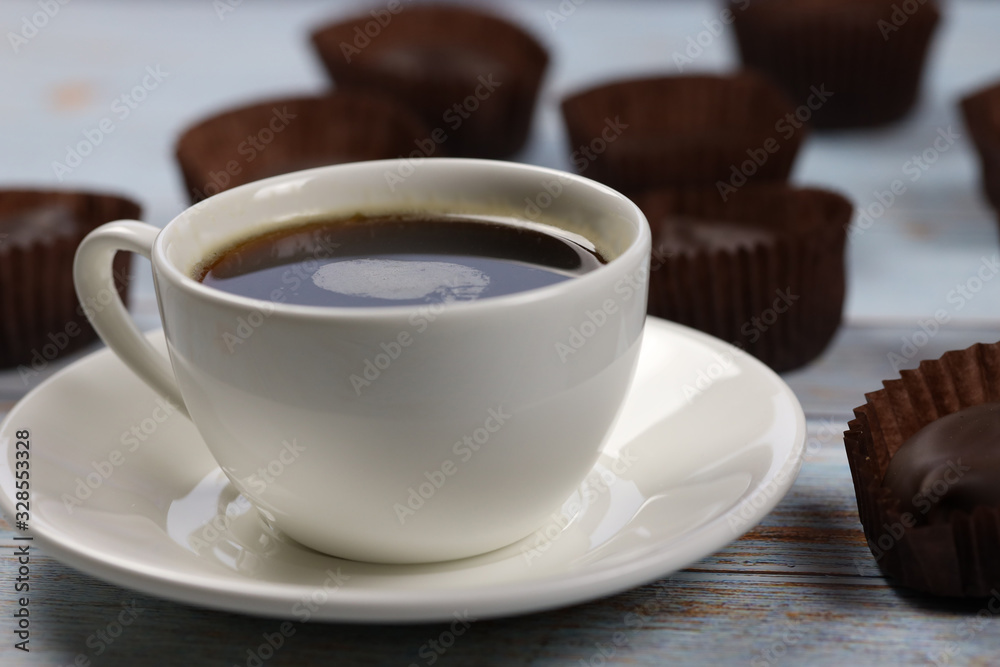 morning cup of coffee and chocolate candies and on the table morning cup of coffee and chocolate candies and on the table