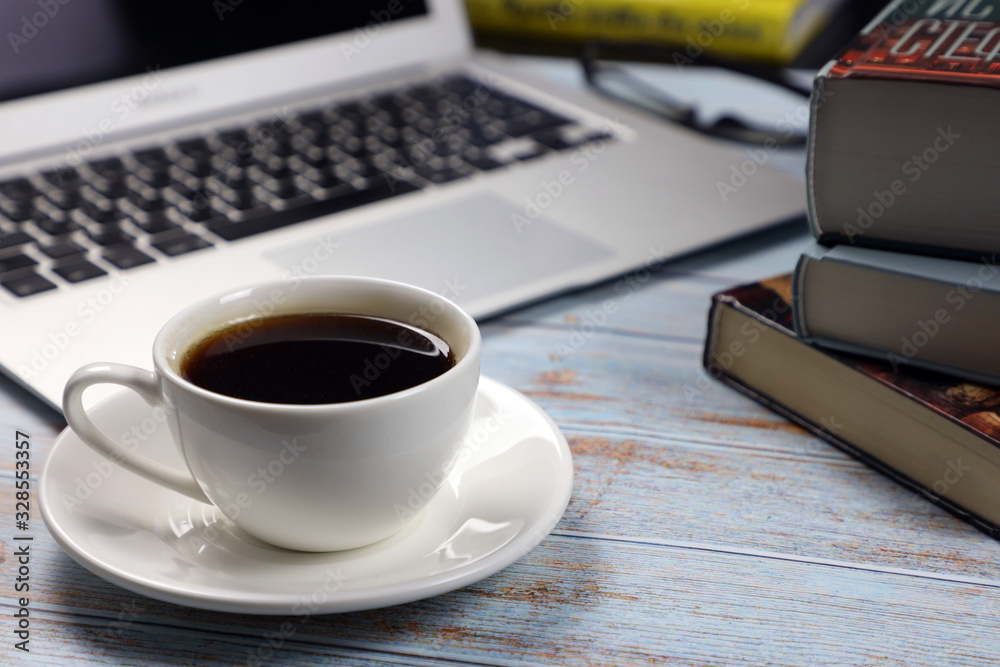 cup of coffee, laptop and books and on the table, business and finance concept cup of coffee, laptop and books and on the table, business and finance concept