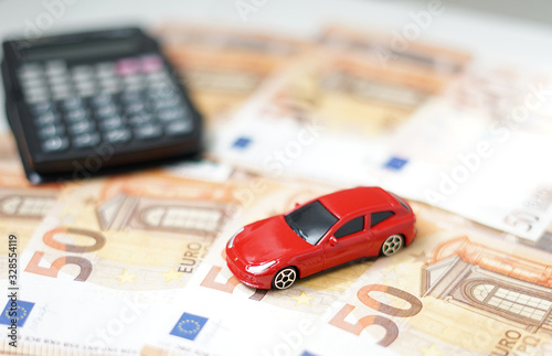 Toy car, money and calculator