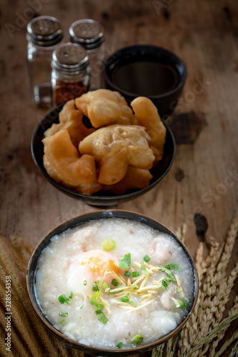 Homemade Thai breakfast, rice porridge and chinese donut on vintage wooden floors