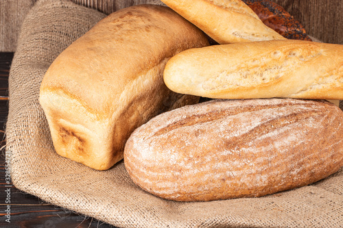 baked bread and baguette on wooden table background