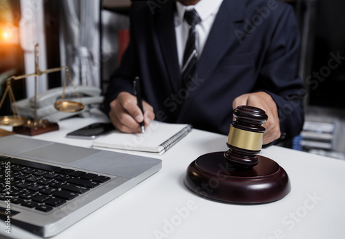 Concepts of Law and Legal services. Lawyer working at office.