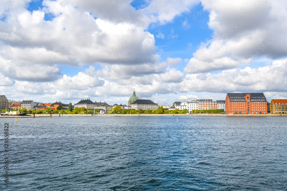 View across the water from Holmen Island of the Amalienborg castle and the Marble or Frederik's Church in Copenhagen Denmark.