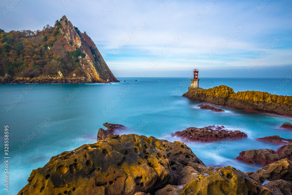 Fototapeta premium Long exposure of the beautiful surroundings of the lighthouse of Pasaia San Juan at dawn. Basque Country