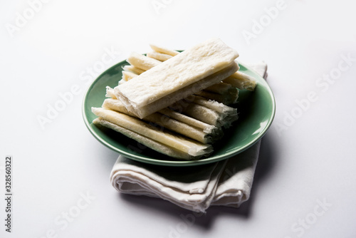 Pootharekulu  is a popular recipe originated from Andhra Pradesh, India.It is a paper-thin sweet or dessert made from rice start/gram flour, jaggery/sugar and clarified butter. Served in a plate. photo