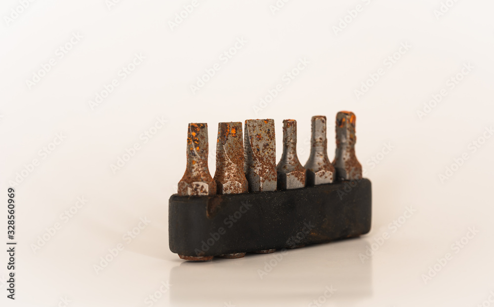 Close-up image of rusty screwdriver bits. Rusty metal tips on white background. Close-up image of rusty screwdriver bits. Rusty metal tips on white background.