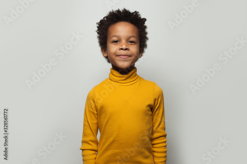 Little black child boy smiling on white background