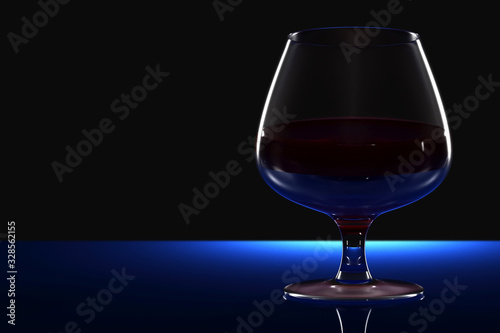 Glass goblet with wine on a mirror surface on a black background. © Sergey