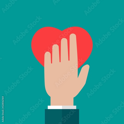 Hand holding red heart on blue background. charity, philanthropy, giving help