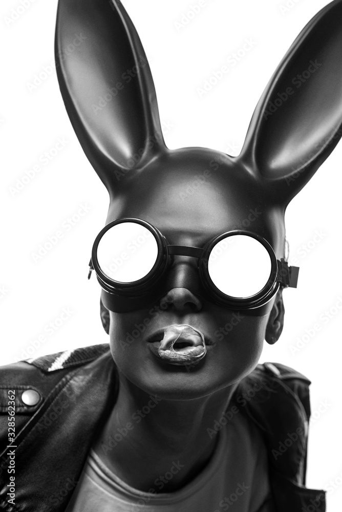 Obraz premium masked easter bunny blowing bubble gum bubbles. Easter party concept
