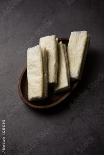 Pootharekulu  is a popular recipe originated from Andhra Pradesh, India.It is a paper-thin sweet or dessert made from rice start/gram flour, jaggery/sugar and clarified butter. Served in a plate. photo