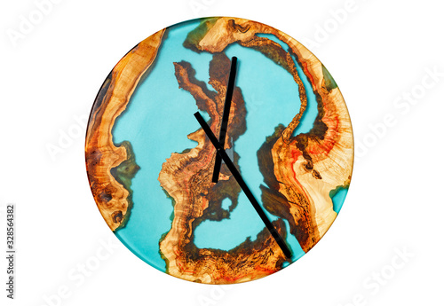 Beautiful wooden wall clock made of tree root and epoxy isolated on a white background.