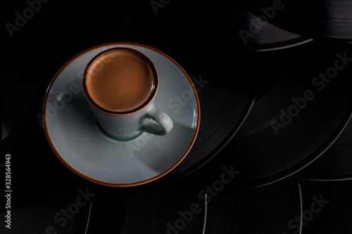 vinyl coffee and milk in white cup isolated on black background movement action