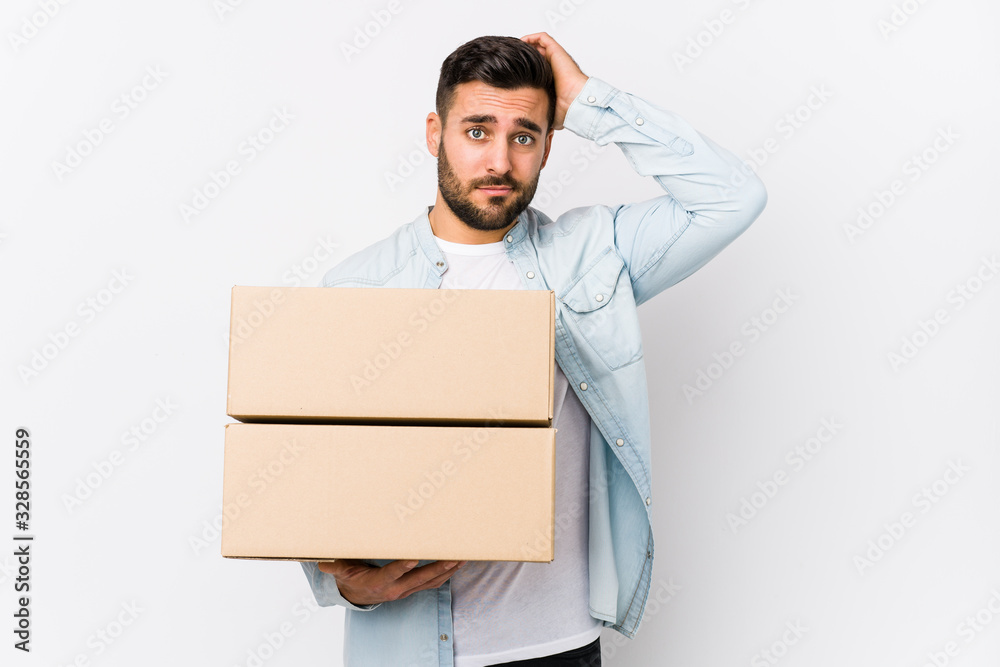 Young caucasian man moving to a new home isolated being shocked, she has remembered important meeting. Young caucasian man moving to a new home isolated being shocked, she has remembered important meeting.