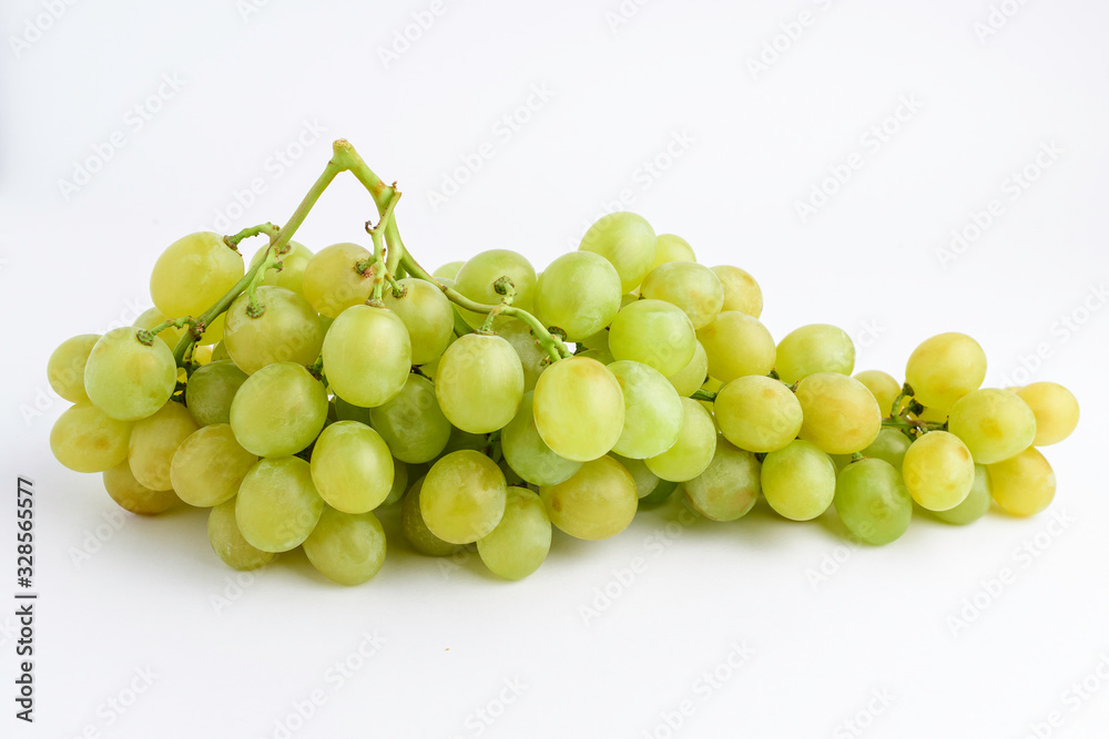 One bunch of ripe organic white grapes isolated on white background, side view