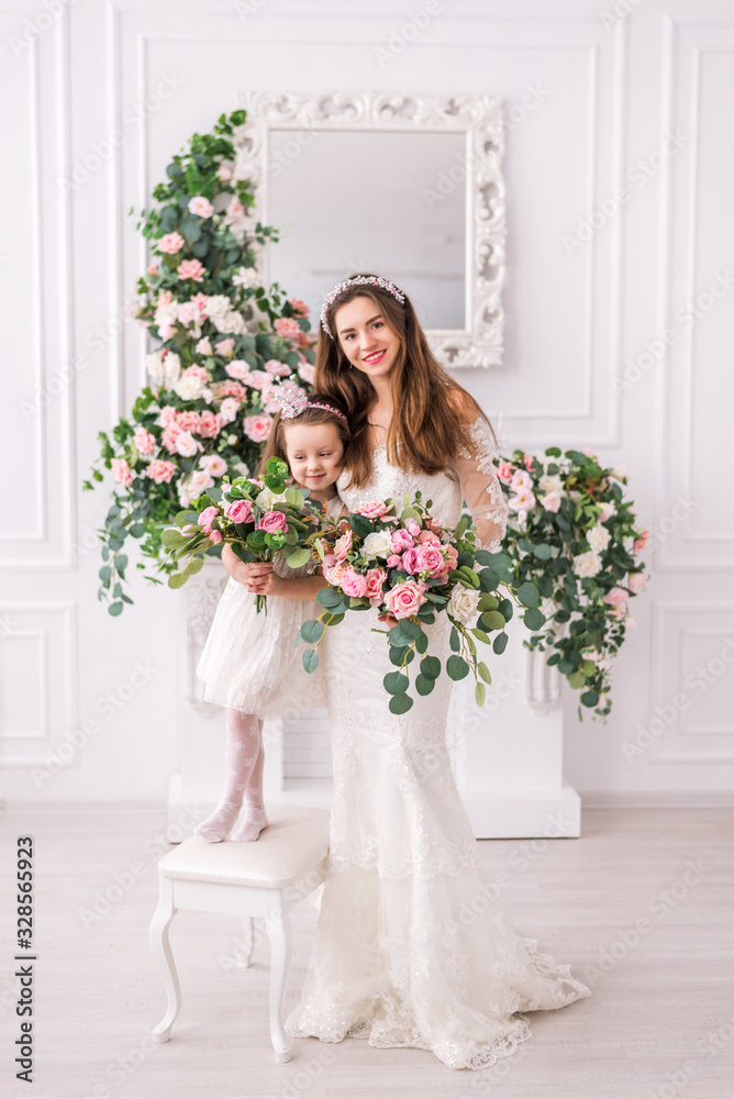 bride mother and daughter in white dresses with flowers. bride mother and daughter in white dresses with flowers.