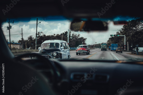 Havana, Cuba; Sep 26 2017: Retro classic American cars drive, viewed from inside car