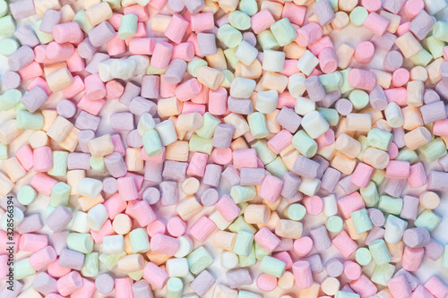 Top View of Pastel Shaped Marshmallow Candies with Some Scattered on the Pale white Table