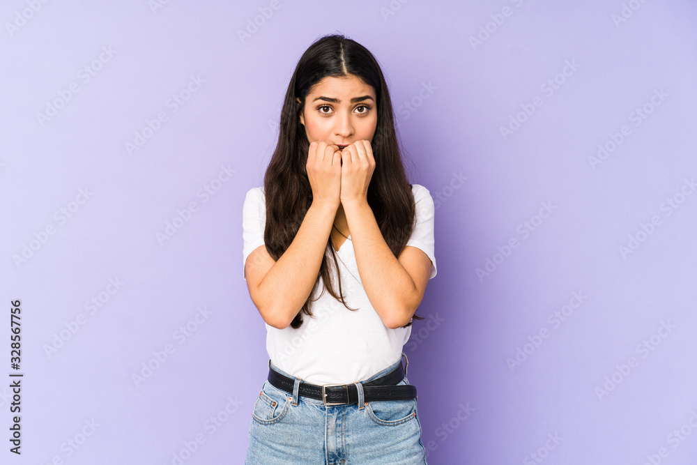 Young indian woman isolated on purple background biting fingernails, nervous and very anxious. Young indian woman isolated on purple background biting fingernails, nervous and very anxious.