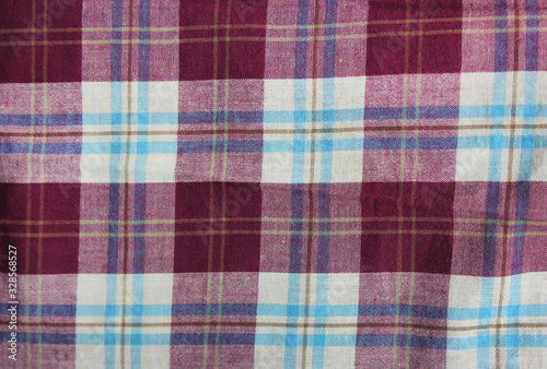 Tartan checkered pattern, purple and white color lumberjack fabric texture. Plaid flannel shirt material, buffalo style design close up top view