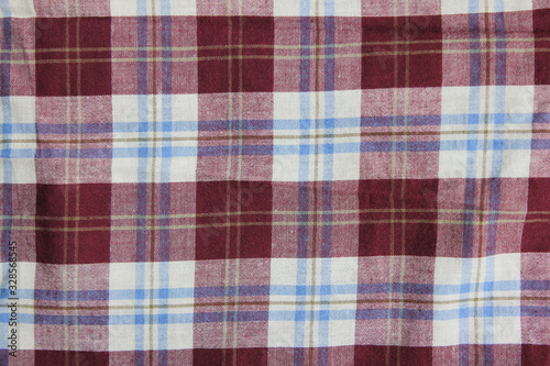 Tartan tablecloth fabric pattern, purple and white colour lumberjack style cloth texture. Plaid or flannel shirt material, buffalo style design fragment close up top view