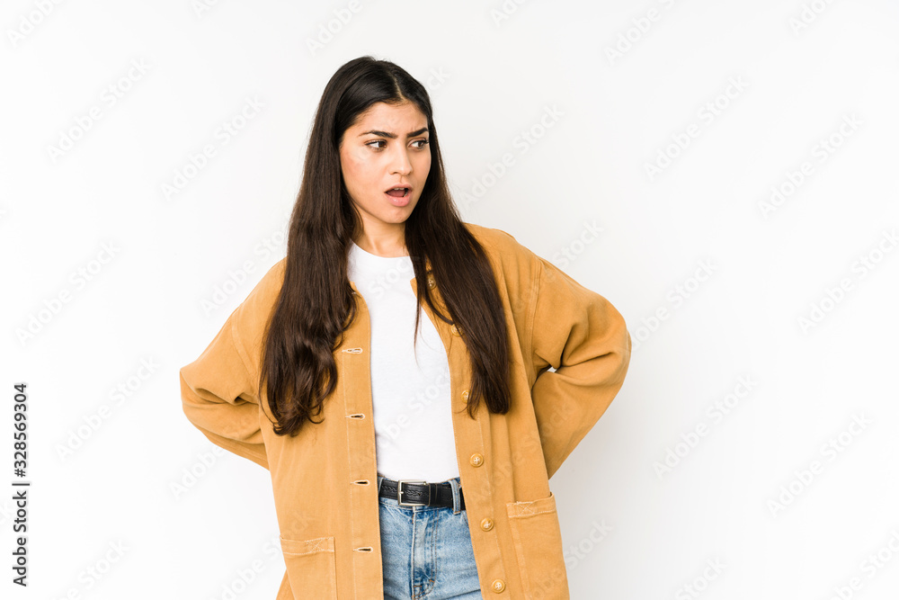 Young indian woman isolated on purple background being shocked because of something she has seen. Young indian woman isolated on purple background being shocked because of something she has seen.