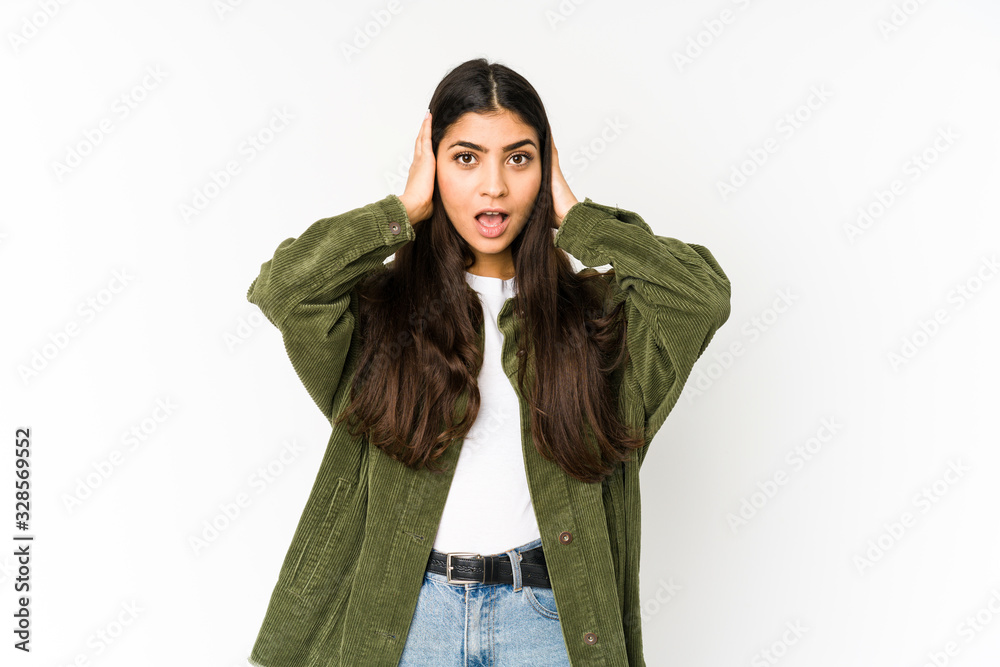 Young indian woman isolated on purple background screaming, very excited, passionate, satisfied with something.