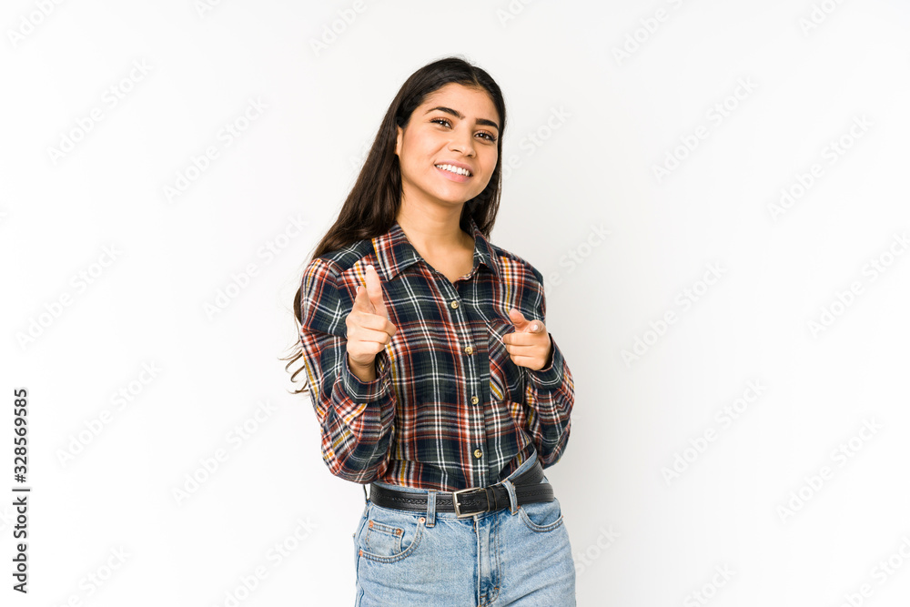 Young indian woman isolated on purple background pointing to front with fingers. Young indian woman isolated on purple background pointing to front with fingers.