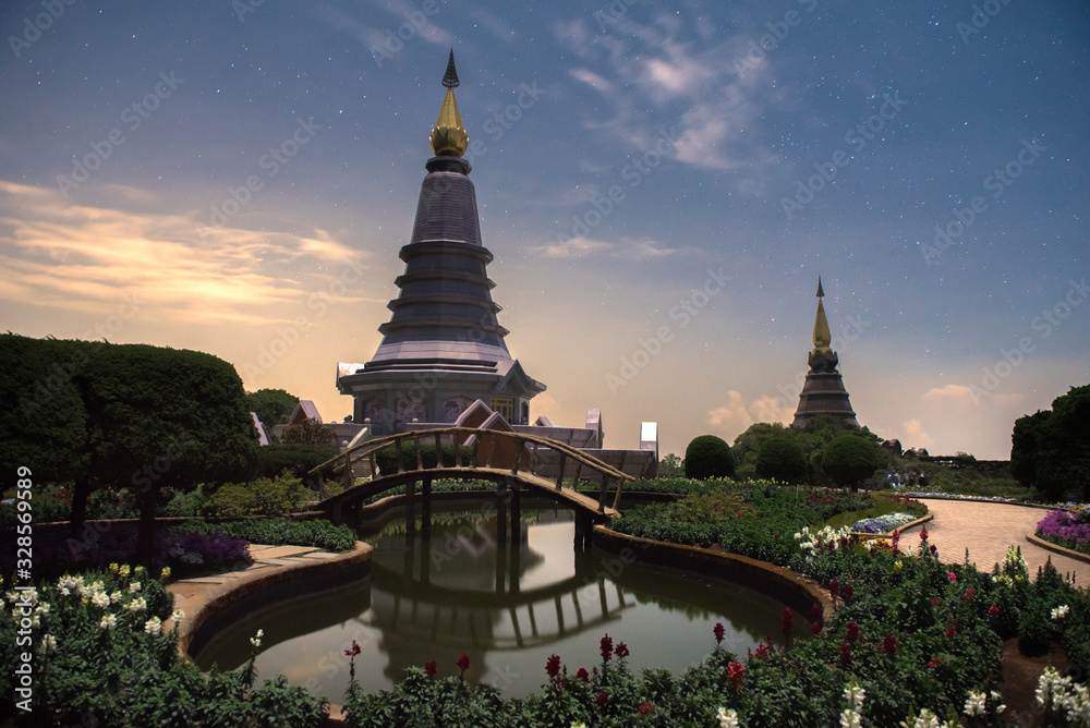 Naklejka premium Beautiful landscape of two pagoda at night, traveling landmarks in Doi Inthanon National Park, Chiang mai, Thailand.