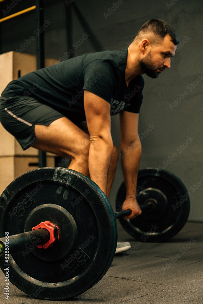 Closeup portrait of a muscular man workout with barbell at gym. Fitness sport concept. Closeup portrait of a muscular man workout with barbell at gym. Fitness sport concept.