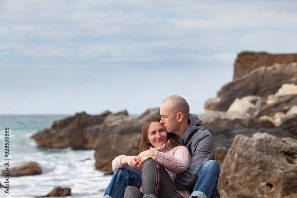 Happy cute couple at sea in winter