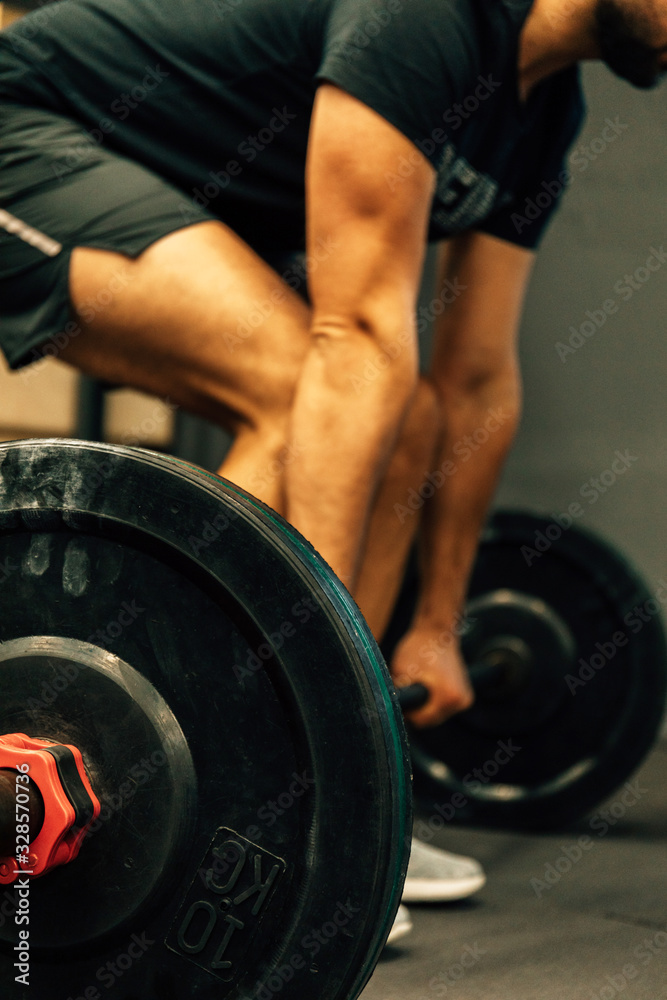Closeup portrait of a muscular man workout with barbell at gym. Fitness sport concept. Closeup portrait of a muscular man workout with barbell at gym. Fitness sport concept.
