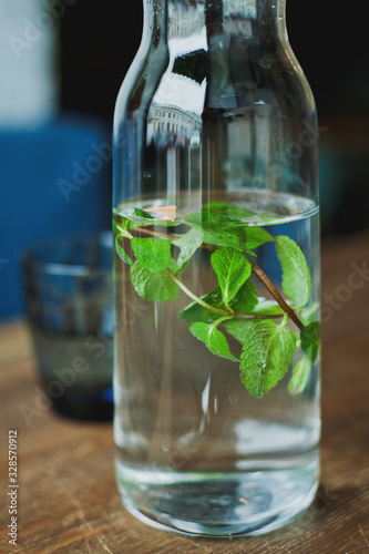 Bottle of water with a sprig of mint