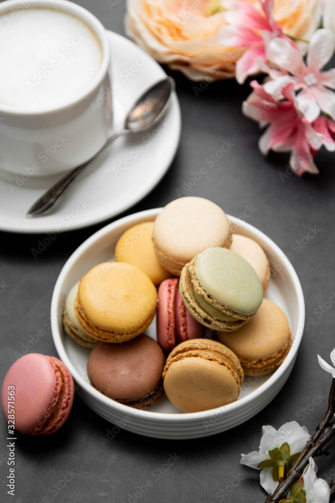 Cup of coffee and macaroons on colorful black background. top view. Cup of coffee and macaroons on colorful black background. top view.