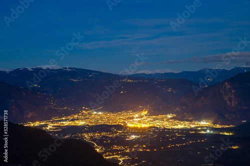 Night view Bolzano city Italy against backdrop of mountains, light of lanterns and stars