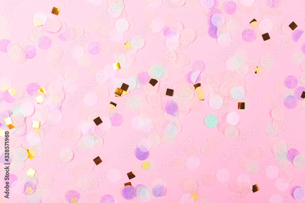 Falling colorful confetti on pink background. Perfect festive background. Flat lay, top view.