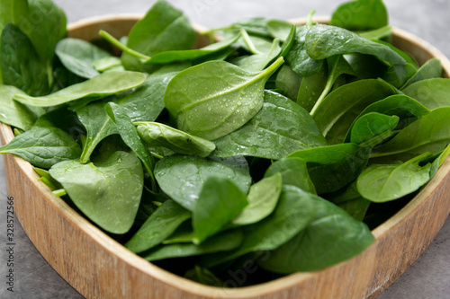 Fresh spinach leaves or spinach salad close up, background