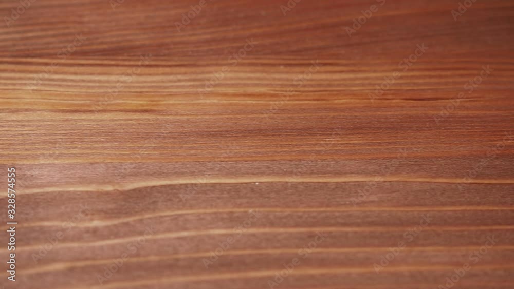 smooth movement of the frame, from right to left, close-up, along the brown wooden surface smooth movement of the frame, from right to left, close-up, along the brown wooden surface