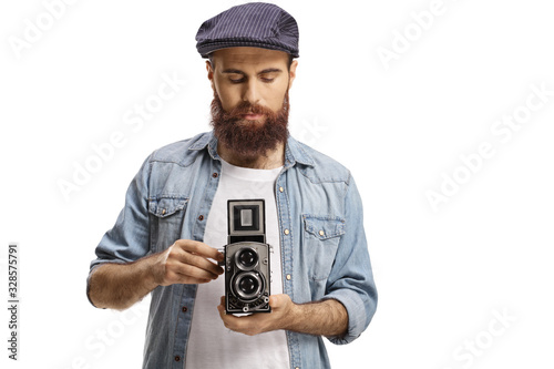 Bearded hipster guy with an old-fashioned camera