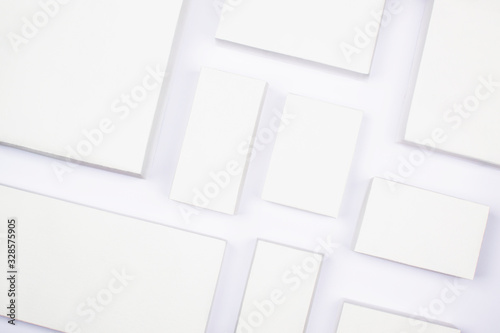 White cardboard boxes on a white background, concept of shopping and delivery. Many boxes of different sizes, packing goods. Recyclable packaging zero waste. Online shopping, buying with gadgets.