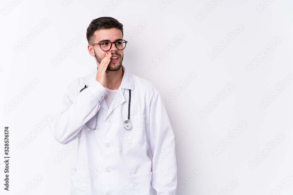 Young caucasian doctor man isolated is saying a secret hot braking news and looking aside Young caucasian doctor man isolated is saying a secret hot braking news and looking aside