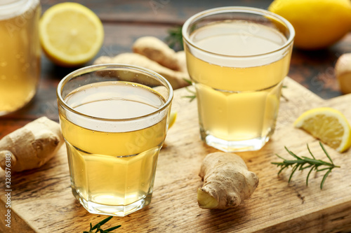 Kombucha Ginger, lemon Tea in glass ,on wooden board. healthy drink